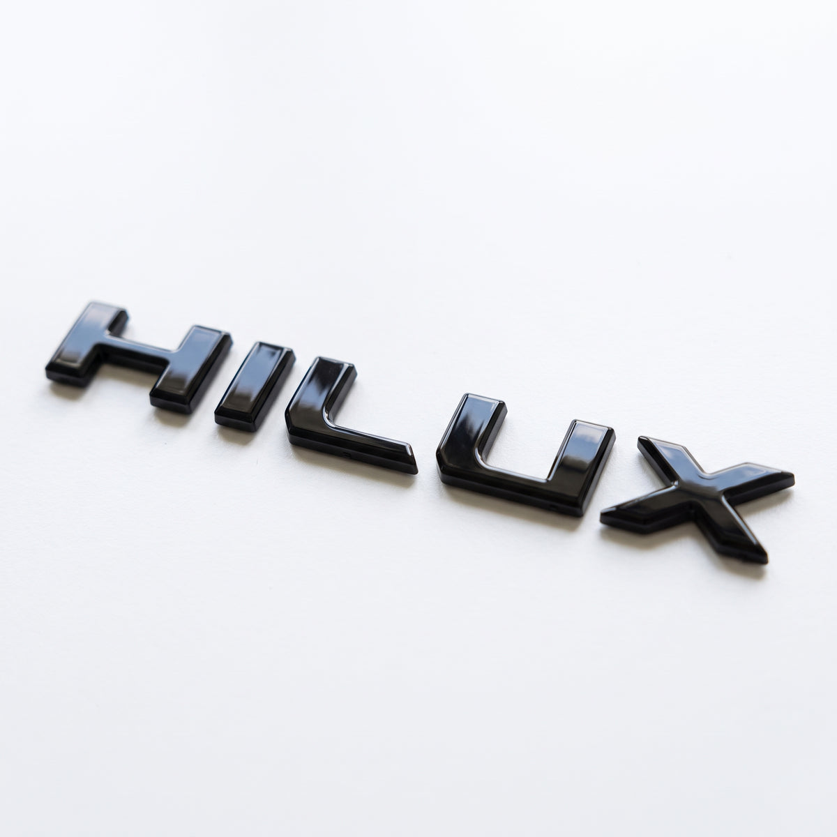 Toyota Hilux Travo (2026+) | 3D Moulded Gloss Black Tailgate Handle Latch Letters- HILUX